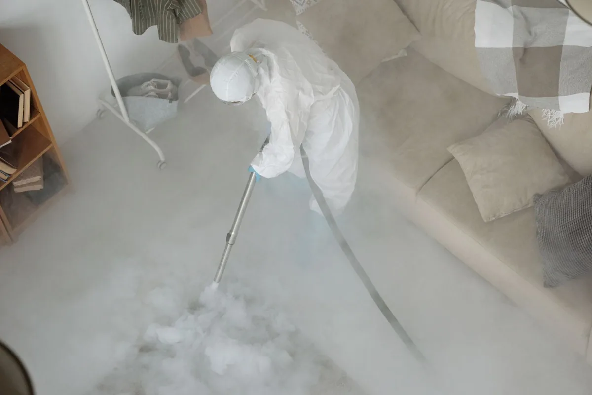 Biohazard cleanup technician in protective equipment, Leachville, AR